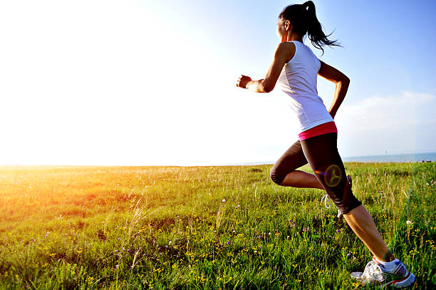istock Runner athlete running on sunrise/sunset grass field 512578123