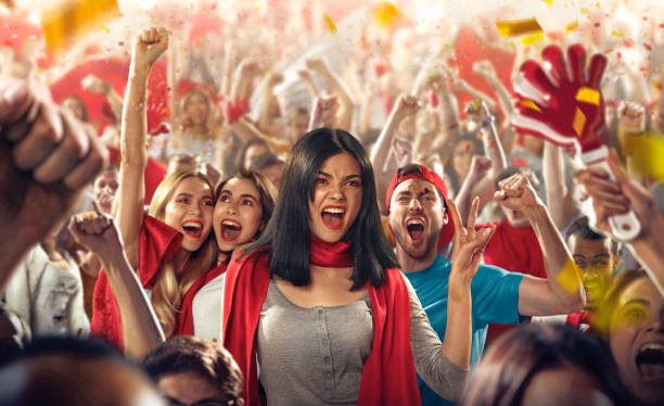 istock Sport fans: A girl show victory sign 512592250