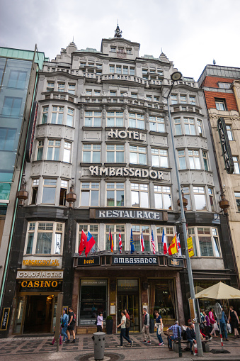 Prague, Czech Republic  - May 9, 2015: Hotel Restaurant Ambassador, Prague. Tourists walking on the street