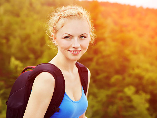 istock woman with backpack hiking in the mountains 512594144