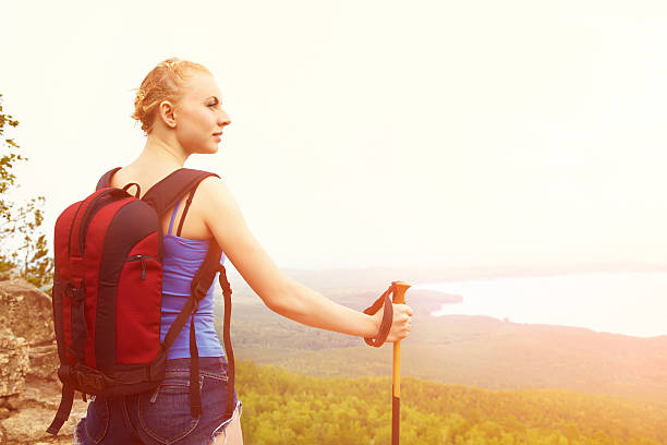 istock woman with backpack hiking in the mountains 512594426