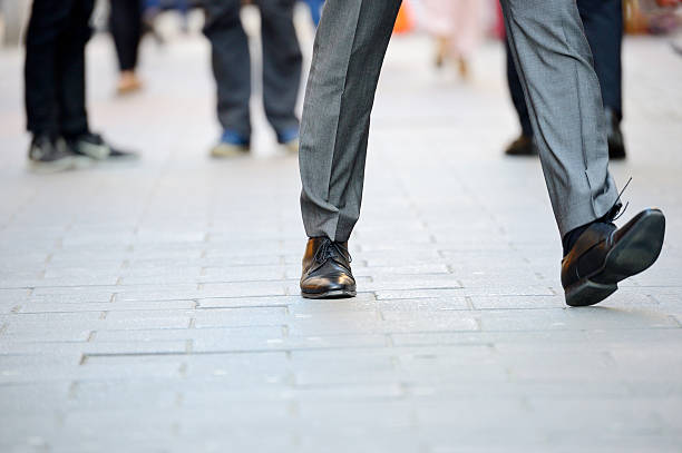 istock Business man in suit taking a big fast step forward 512594944