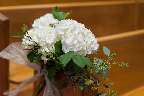 Flowers decorating church pews for wedding