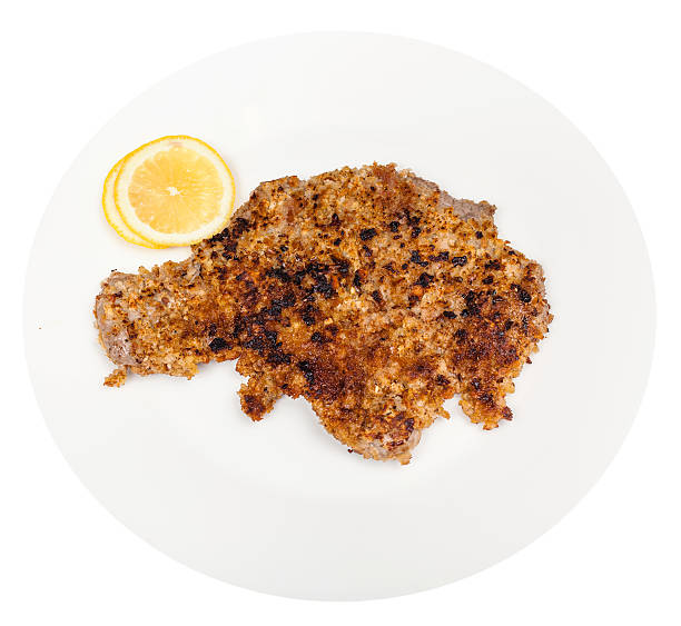 istock fried veal schnitzel and lemon slices on plate 512597486
