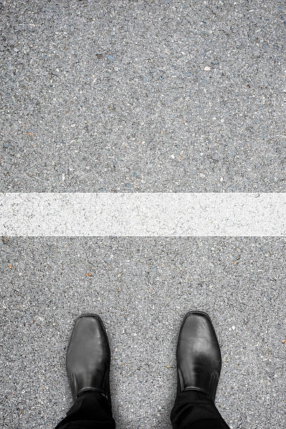 istock Black shoes standing at the white line 512597908