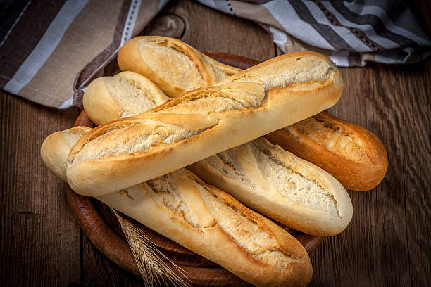 istock French baguettes on old wooden table. 512598352