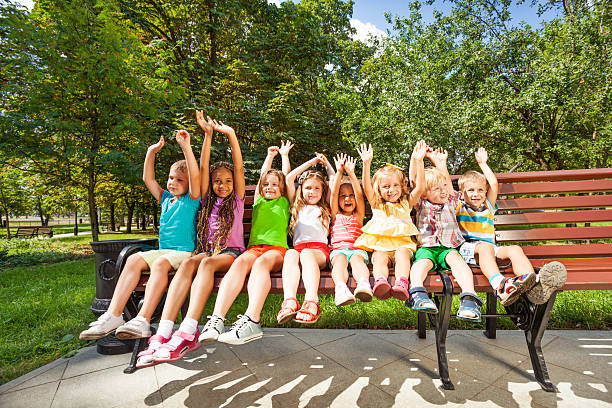istock Happy children in park bench 512600411
