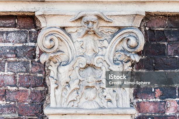 Ancient And Scorched Stone Ornament With A Demon Face Stock Photo - Download Image Now