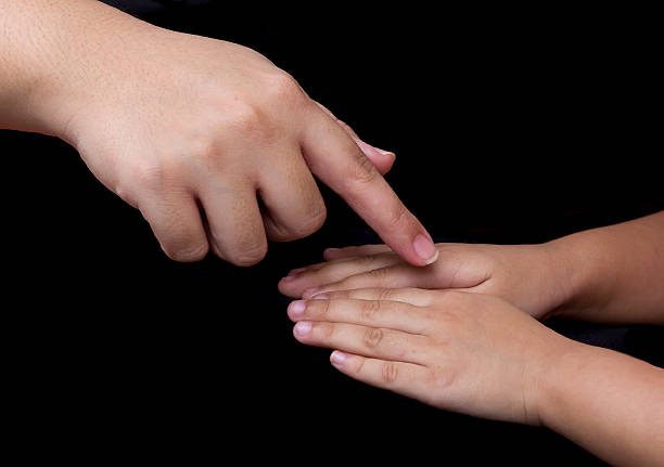 istock Mother point her finger to child's hand that tern over. 512601097