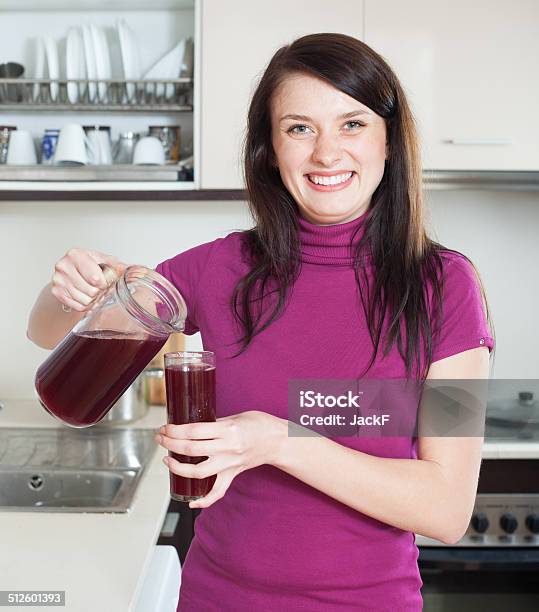 Happy Woman Pouring Fruitdrink Or Juice From Jug Stock Photo - Download Image Now - 20-29 Years, Adult, Adults Only