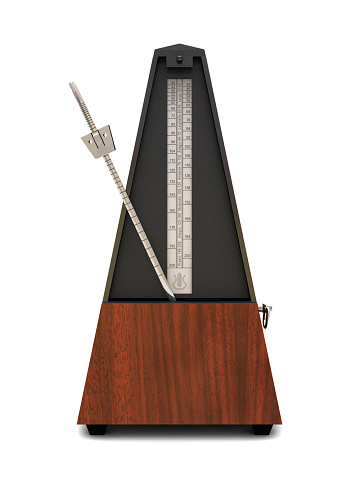 A musical metronome with the pendulum moving to the left on white background. Clipping path included, copy space.