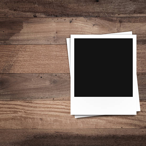istock blank photo frames on brown wood texture background 512603443