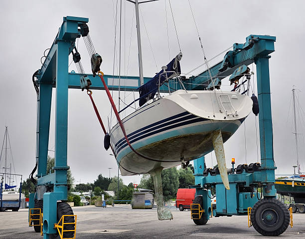 istock Crane lifting boats at harbor 512604785