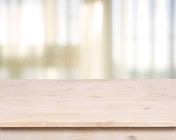 istock Wooden table on defocuced window with curtain background 512605487