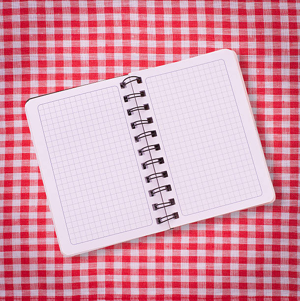 istock Pure notebook for recording menu, recipe on tablecloth tartan. 512605805