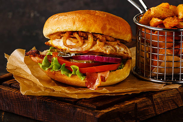 istock Burger with chicken breast and potato wedges 512619534