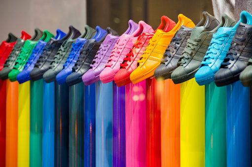 Rome, Italy - April 30, 2015: A leather shop in Rome, Italy displays a wide selection of colorful tennis shoes for sale.