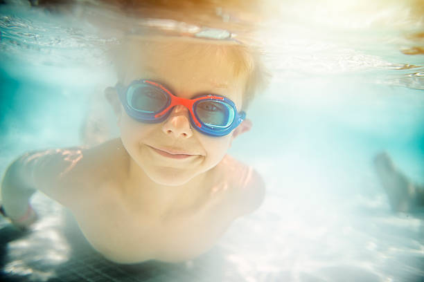 istock Little boy swimming underwater 512620426