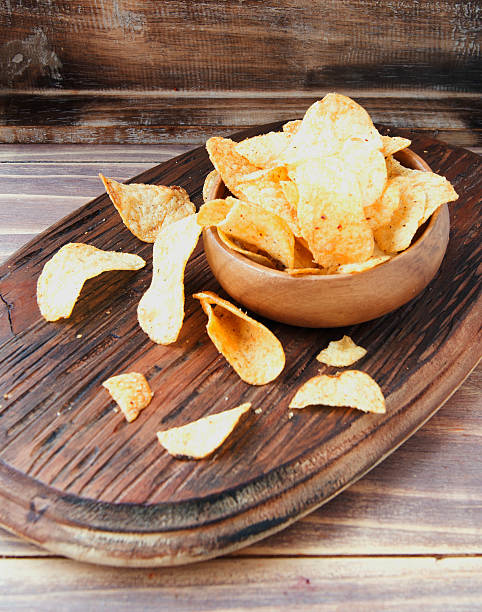 istock Chips in a wooden bowl on table 512620842