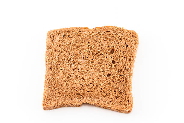 istock Whole wheat toast isolated on white 512622480