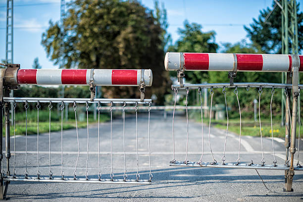 Metal barricades stacked together outdoors on a sunny day.
