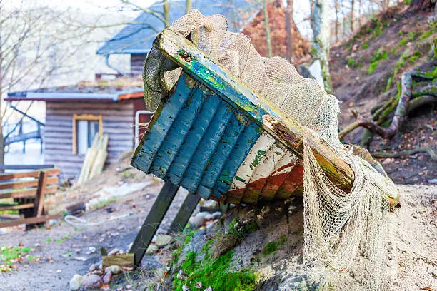 Fishing equipment. Closeup of old net. White fishnet on shore outdoor.