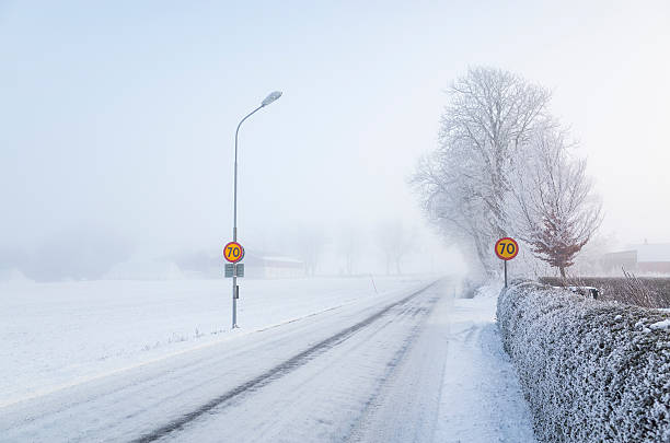 istock Wintry snow-covered country road and landscape 512626510