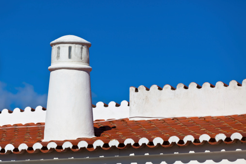 Unrecognizable Part of Residential House at Algarve, Portugal. Bright Blue Sky as a Background