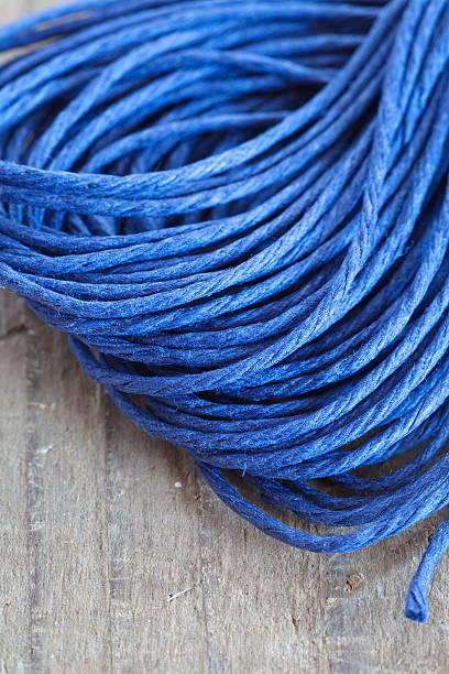 istock Close - up blue hemp ropes on wooden background 512626997