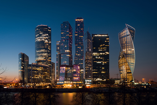 View on International Moscow City Business Center in the sunset from another side of the river on the embankment