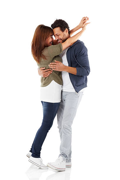 Portrait of romantic mixed race couple embracing Full length portrait of romantic mixed race couple embracing each other over white background couple isolated wife husband stock pictures, royalty-free photos & images