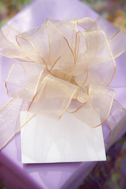 istock Purple wrapped birthday gift with blank card. 512630438