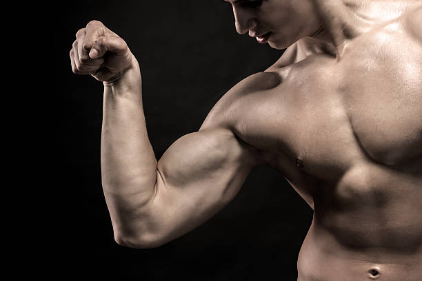 istock Close-up of man flexing showing his triceps, biceps muscles 512630738