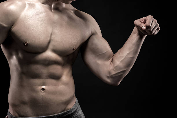 istock Close-up of man flexing showing his triceps, biceps muscles 512630836