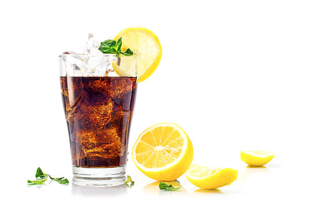 istock glass of cola with ice and lemon isolated on white 512631522