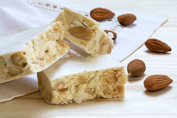 istock Italian festive torrone or white nougat with almonds, close up 512631678