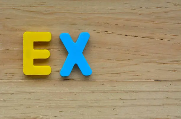 Flat lay of the word Ex on a wooden background.  Relationship concept with copy space for text