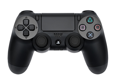 Ufa, Russia - 26 February, 2016: The new Sony Dualshock 4 with PlayStation 4. Sony PlayStation 4 game console of the eighth generation.