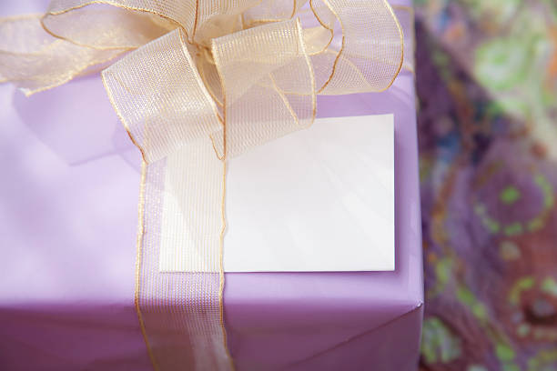 istock Purple wrapped birthday gift with blank card. 512636384