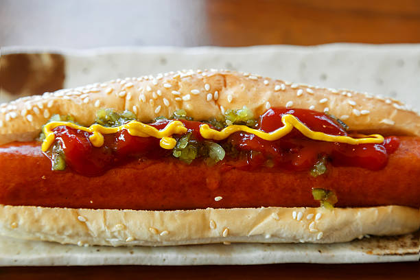istock Hotdog with a Big Sausage in a Plate on a Table 512637488