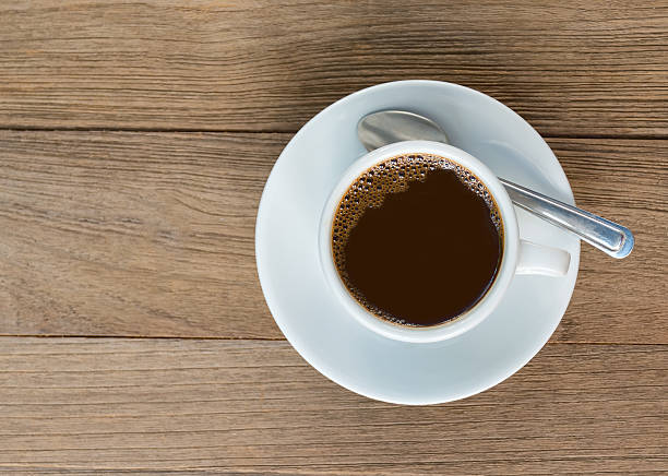 istock Cup of coffee on wooden table, top view 512638540