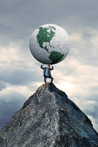 istock Businessman Standing On Mountain Top Holding A Globe 512638718