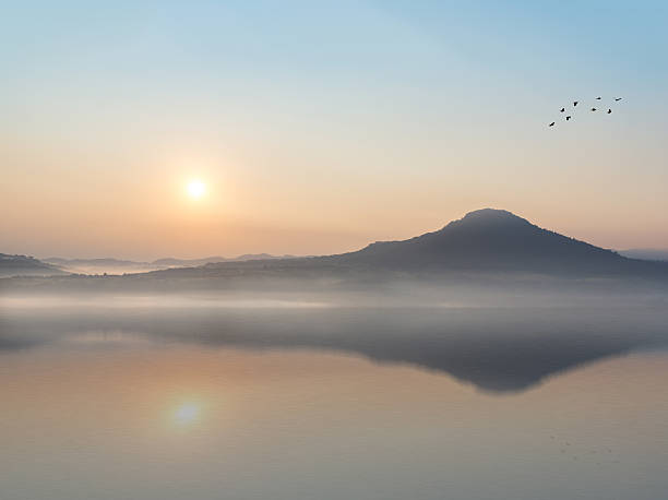 istock beautiful sunrise and mountain with Water Reflection. 512639586