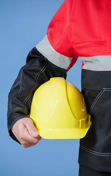 istock Fragment of a builder holding yellow hard hat 512639928