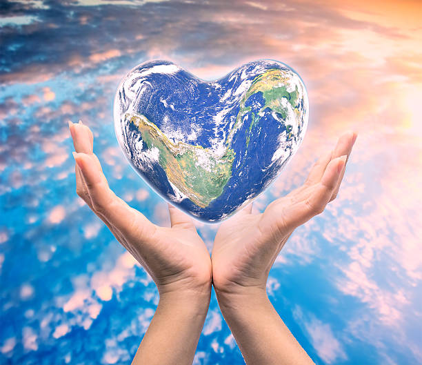 istock World in heart shape with over women human hands 512640164