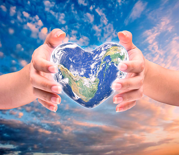 istock World in heart shape with over women human hands 512640536