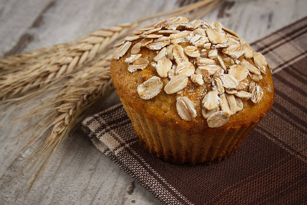 istock Muffin with oatmeal, ears of rye grain on checkered tablecloth 512684048