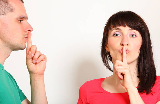 istock Woman and man showing hand silence sign 512685282