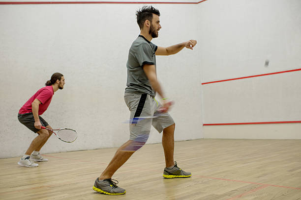 istock Two athletic men playing racketball on a court. 512685658