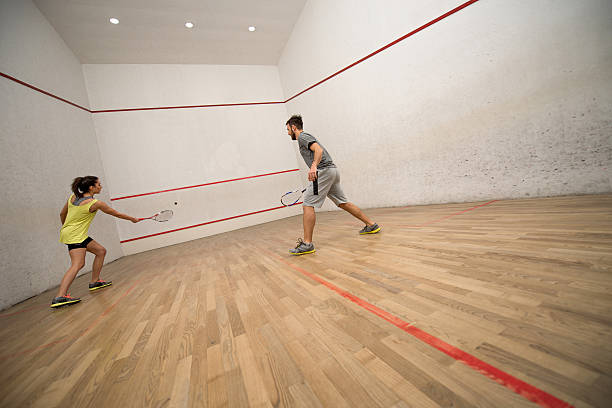 istock Young couple exercising squash on a court. 512686188